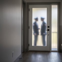 Police officers at a residential front door in Illinois