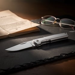 Closed pocketknife on a desk — Illinois knife laws and weapons defense in Joliet
